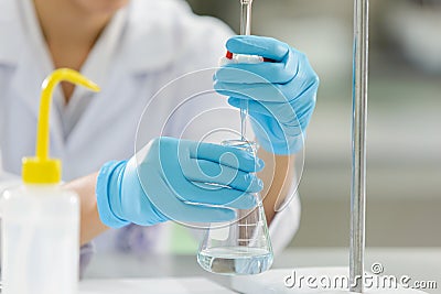 The woman whoâ€™s the scientist is demonstrate the titration technique Stock Photo